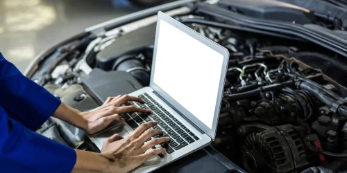 hands-female-mechanic-using-laptop